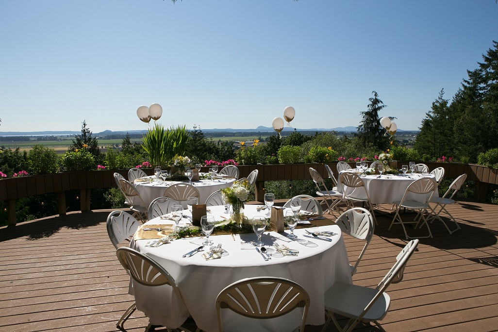 A large outdoor event with tables and chairs set up for an occasion.