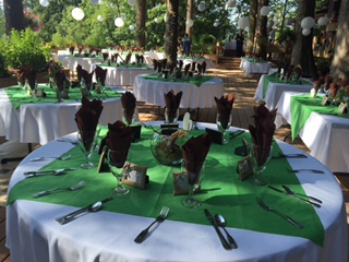 A table with green and white cloth covered tables.