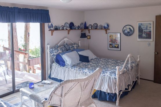 A bedroom with blue and white decor is shown.